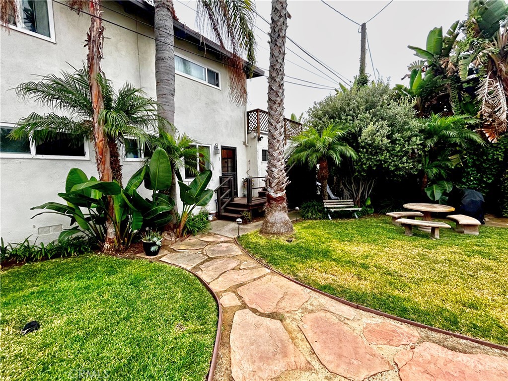 a backyard of a house with table and chairs