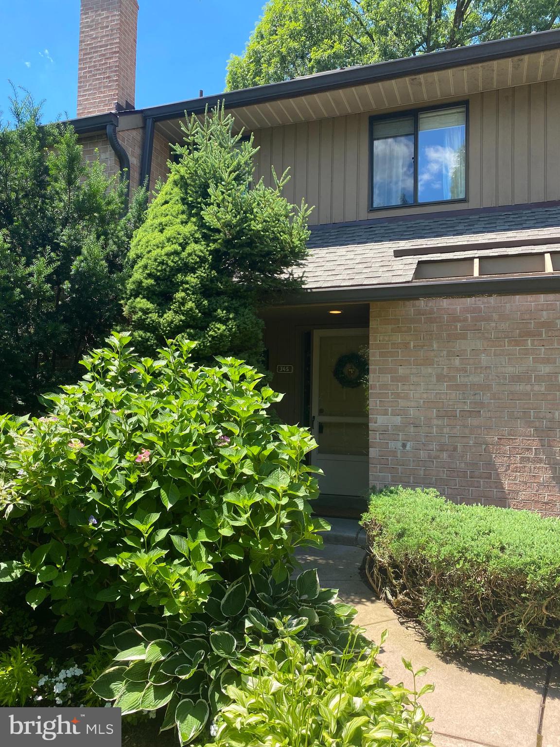 a view of a house with a flower garden