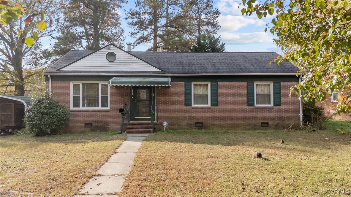 Bungalow-style home with a front lawn