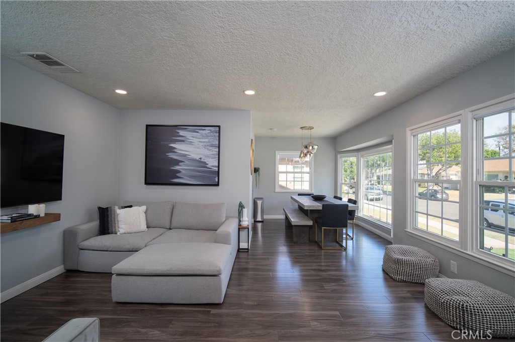 a living room with furniture wooden floor and a flat screen tv