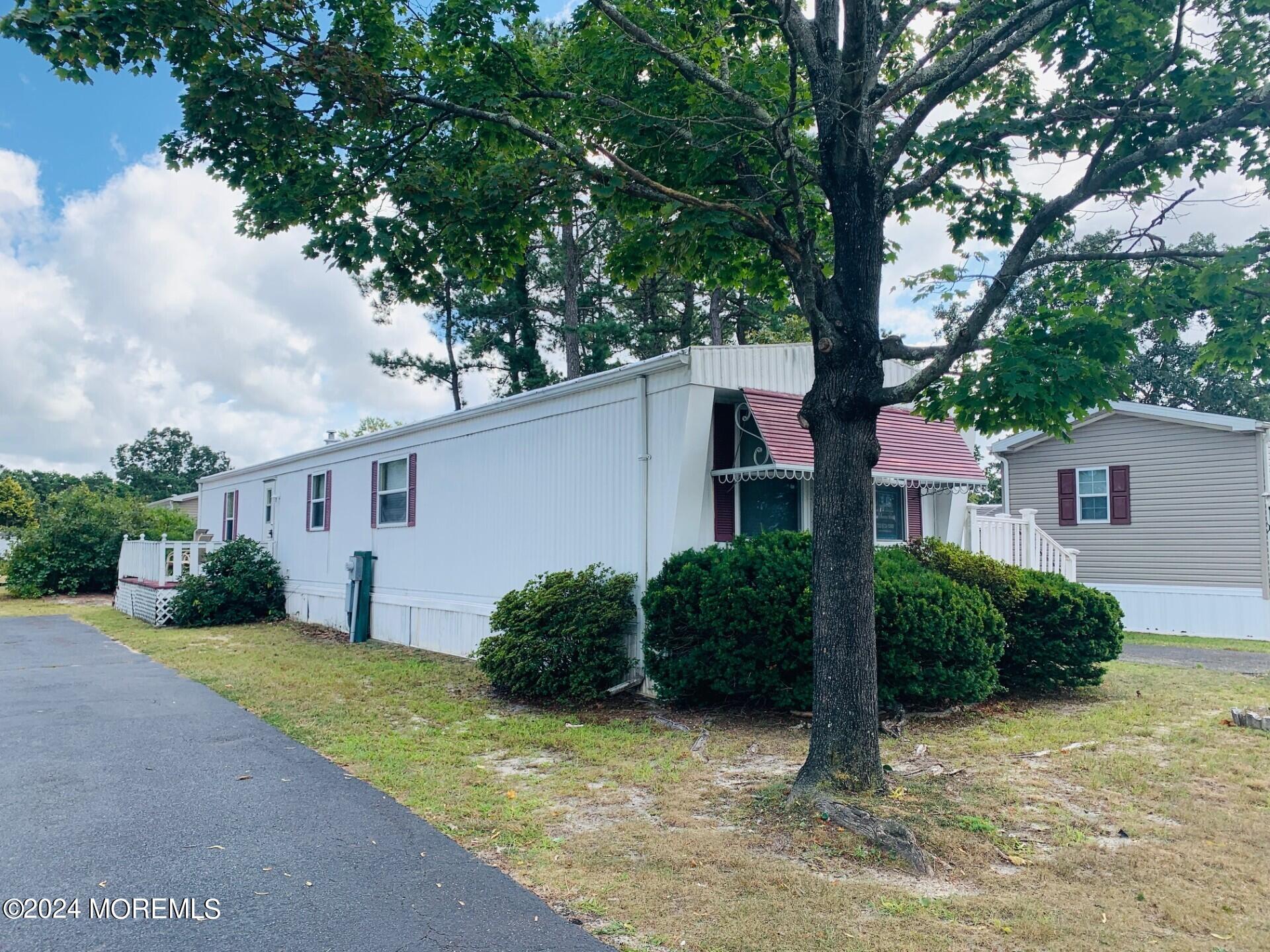 a view of a house with a tree in front of it