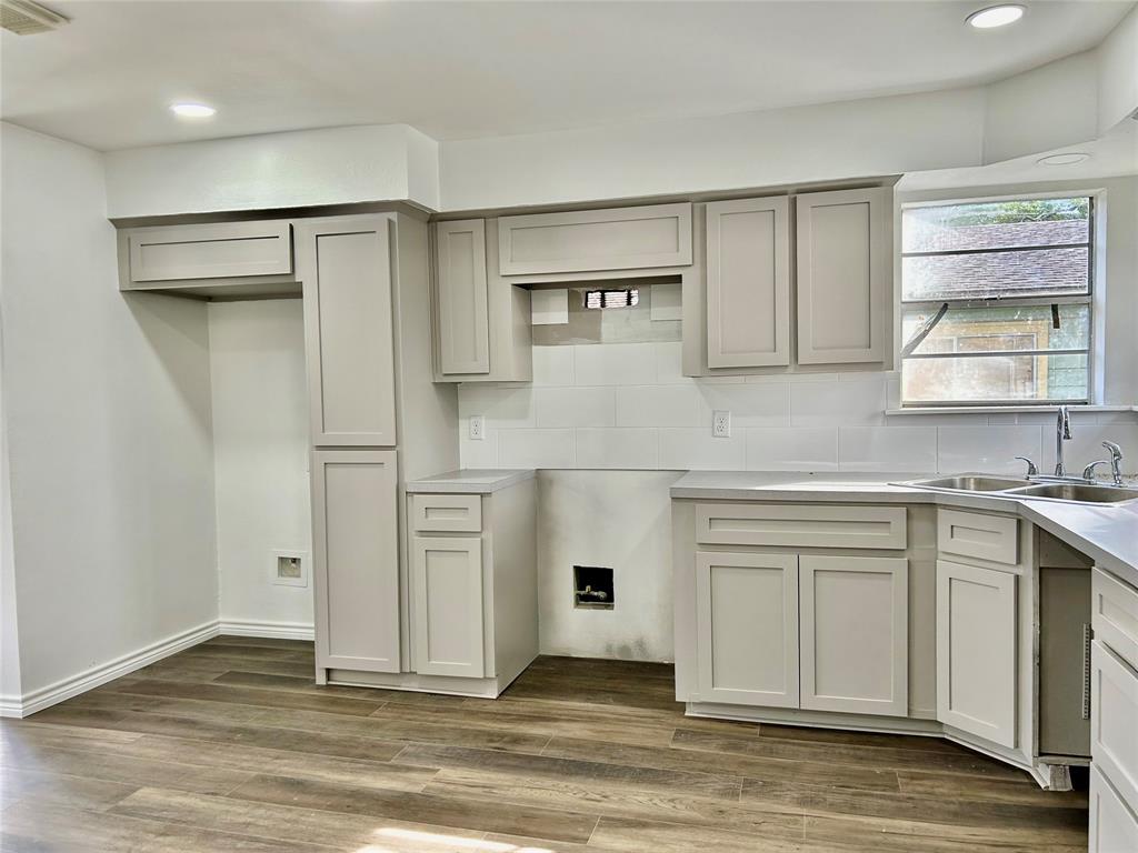 a kitchen with white cabinets and a refrigerator