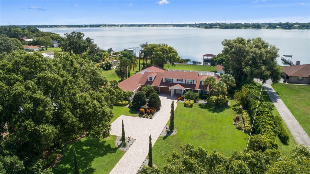 a view of a lake with a garden and houses