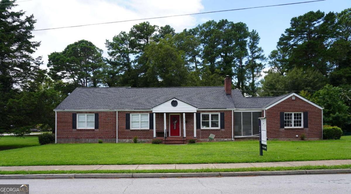 a front view of a house with a garden