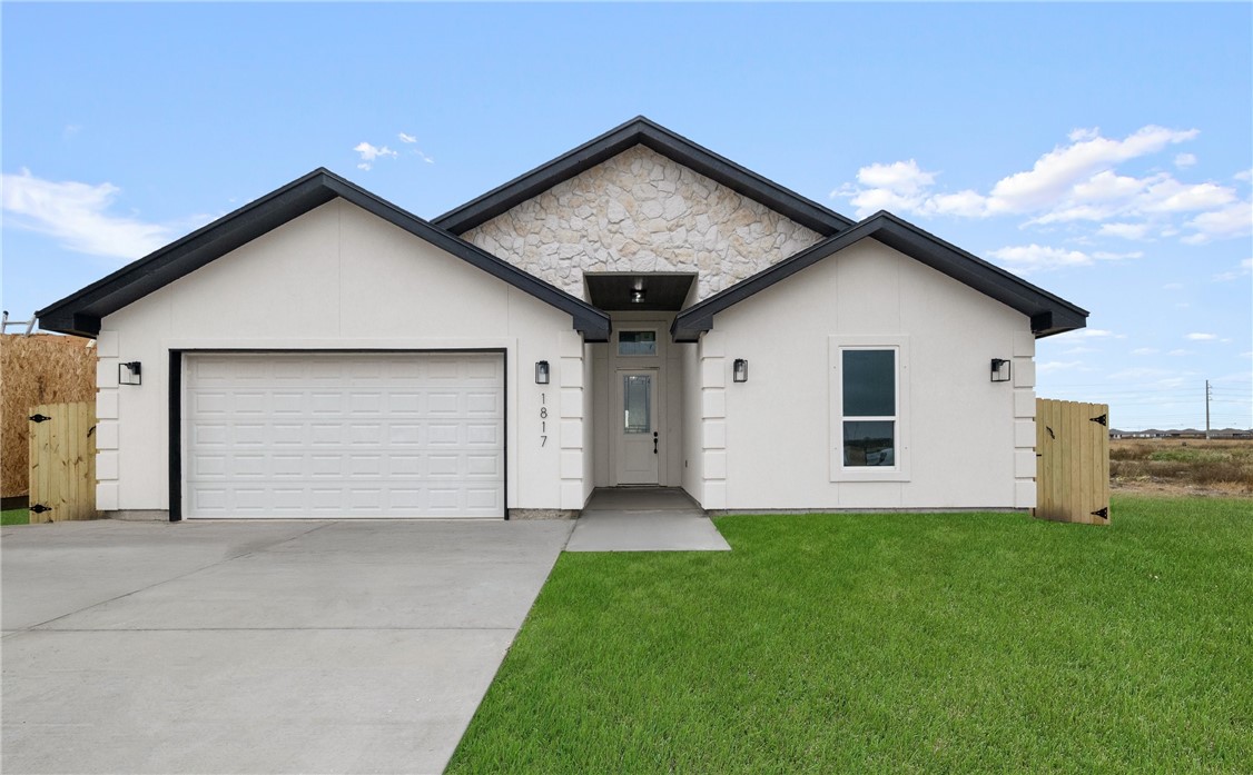 a front view of house with yard and garage