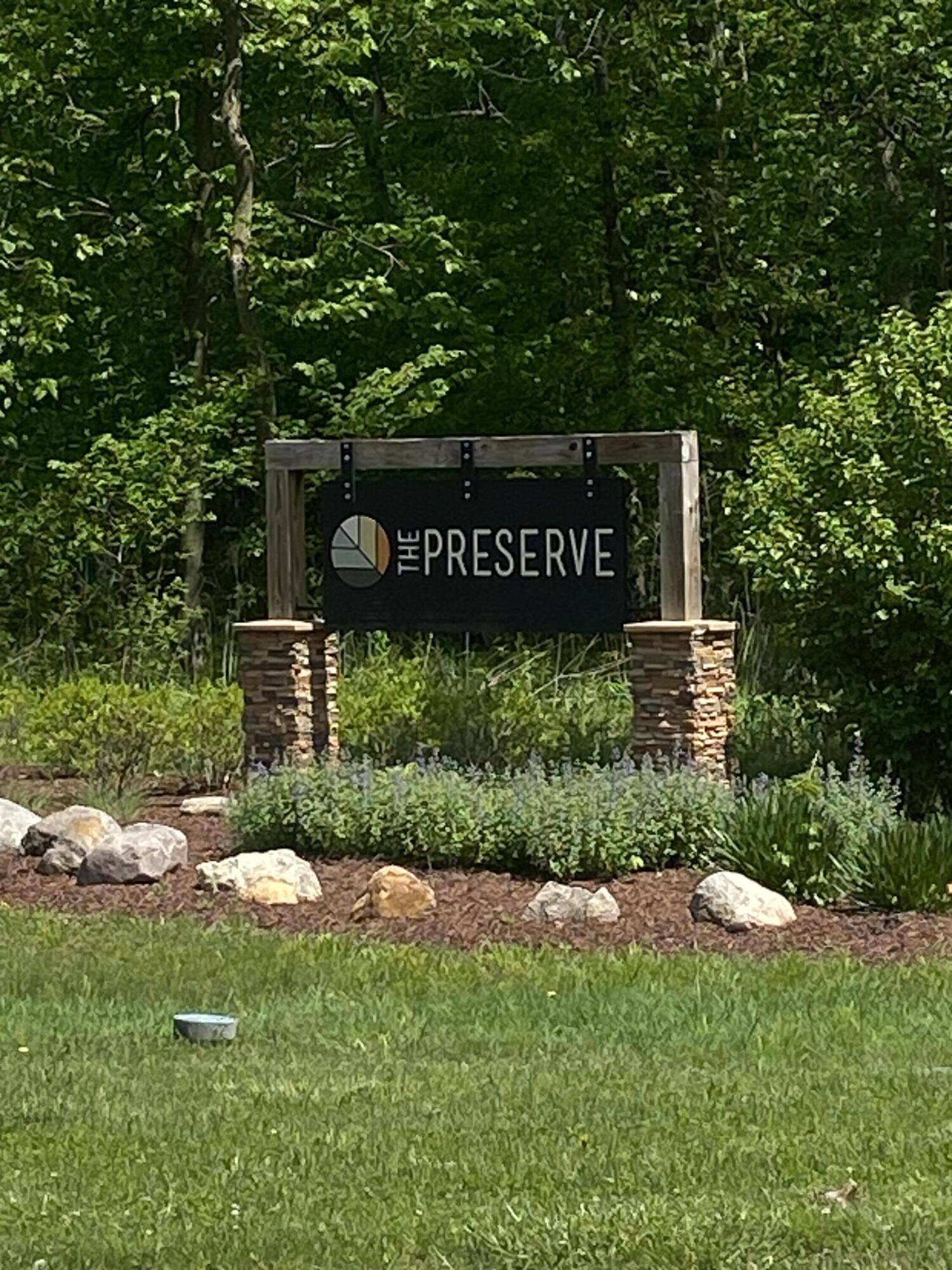 a view of a street sign under a large tree