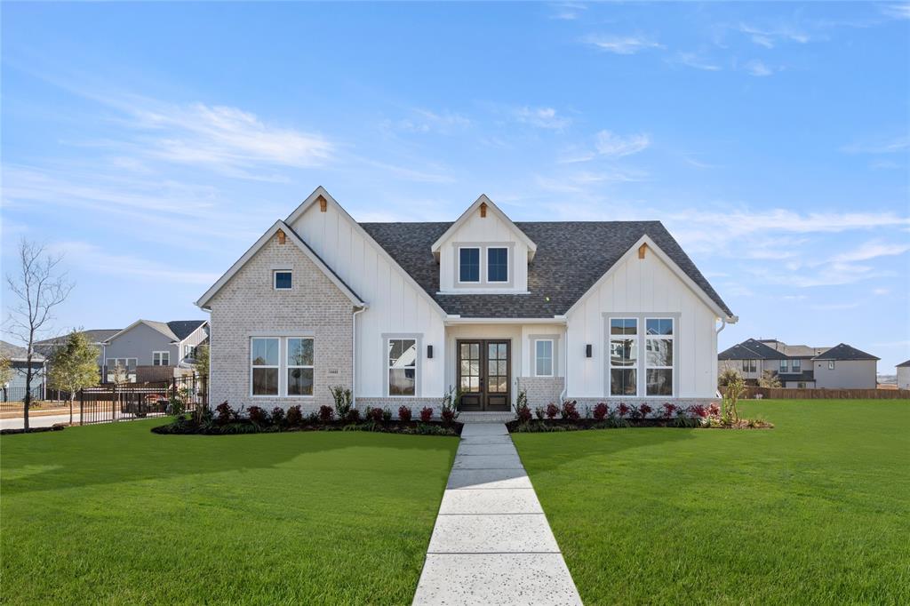 a front view of a house with a yard and trees