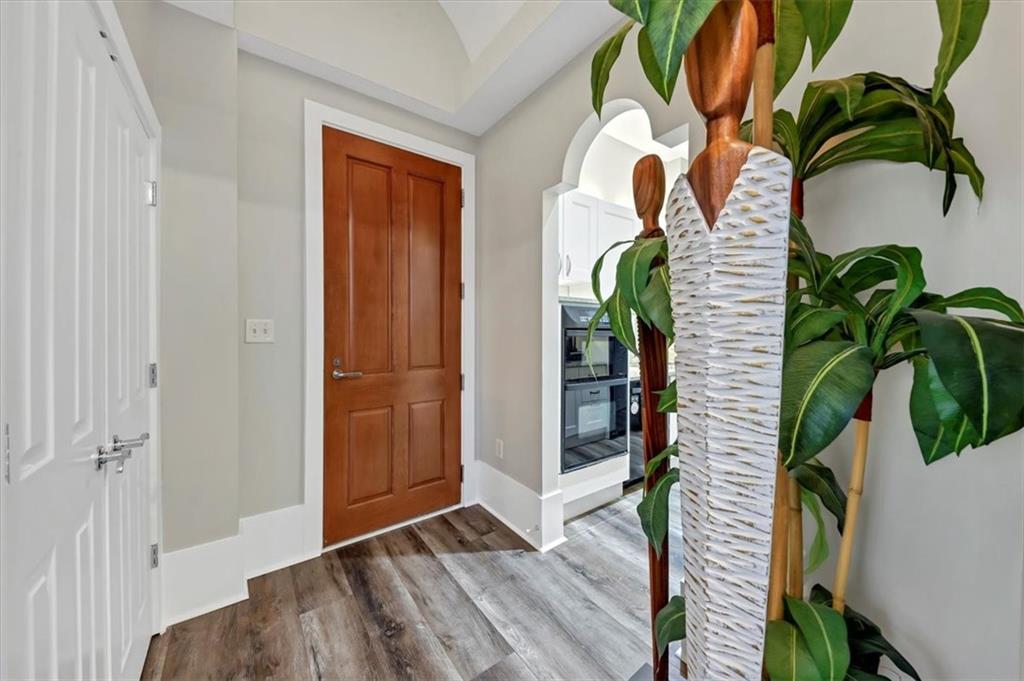 a vase of flowers with wooden floor