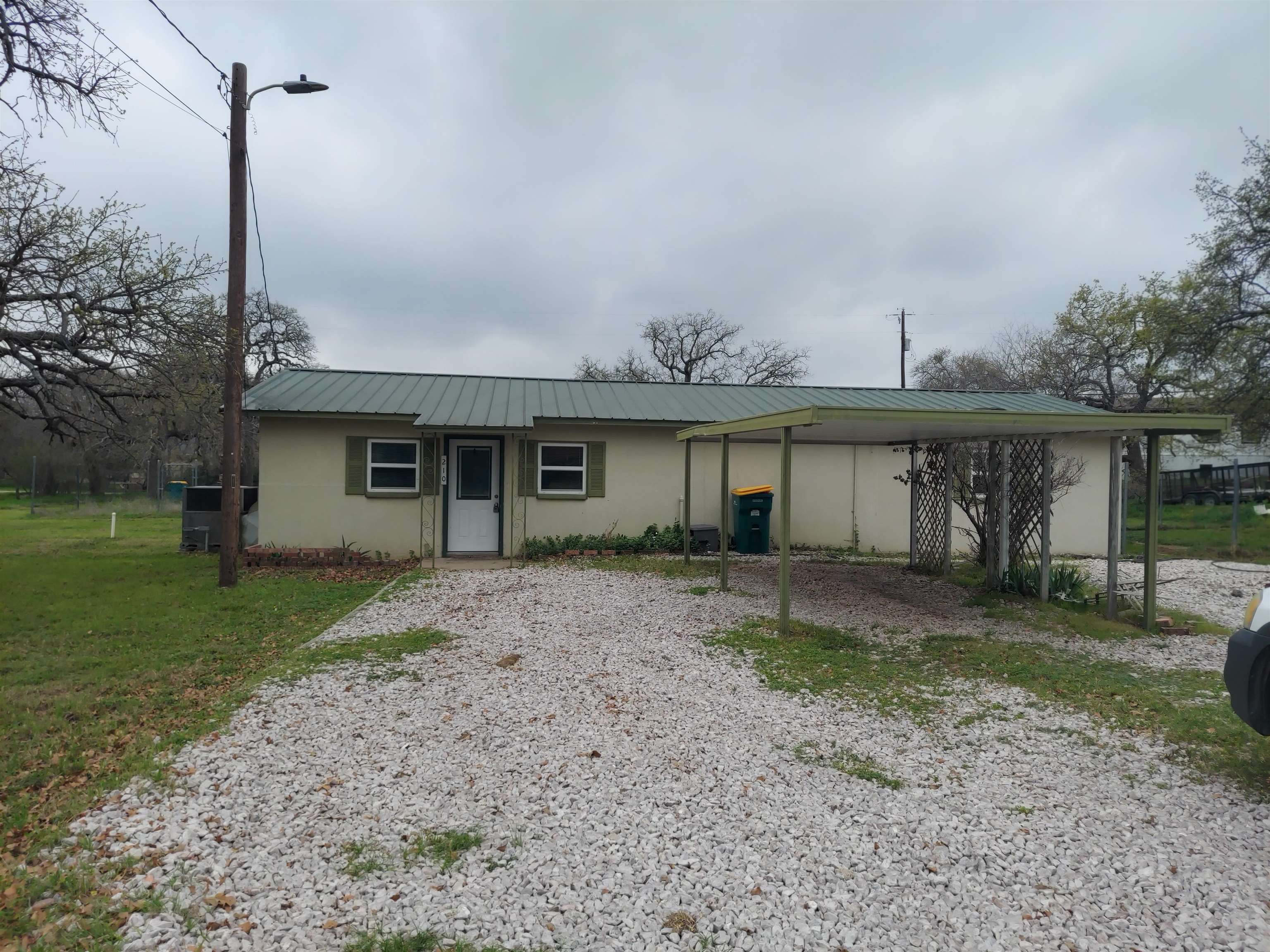 a view of a house with a backyard and a tree