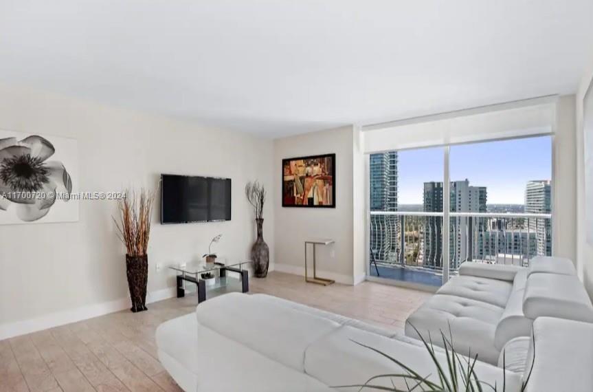 a bedroom with furniture and a flat screen tv