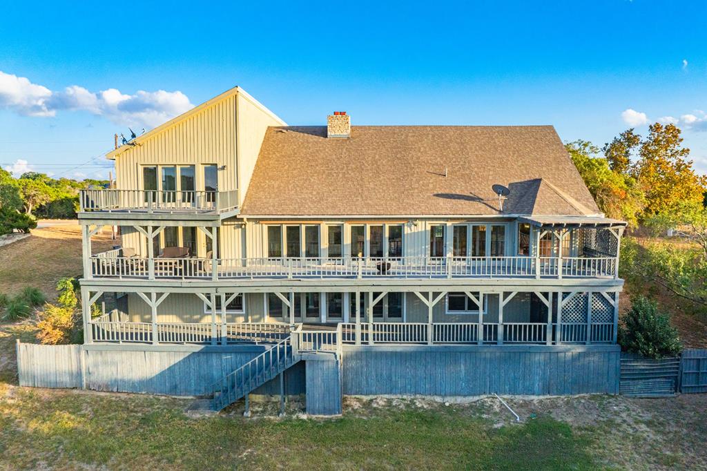 a view of a house with pool and sitting area