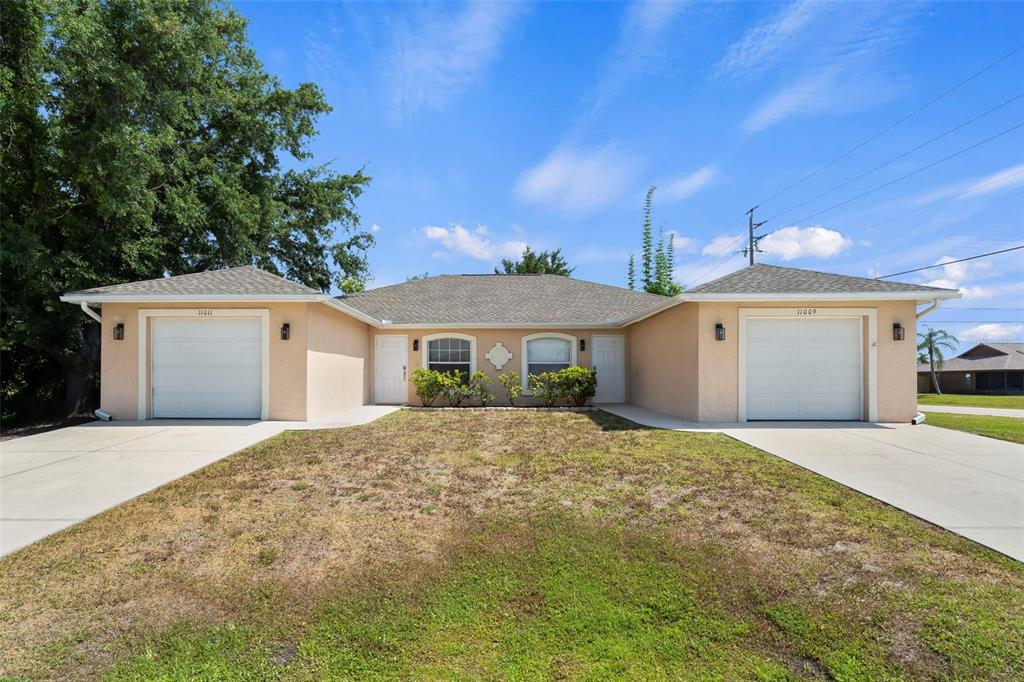 a front view of a house with a yard and garage