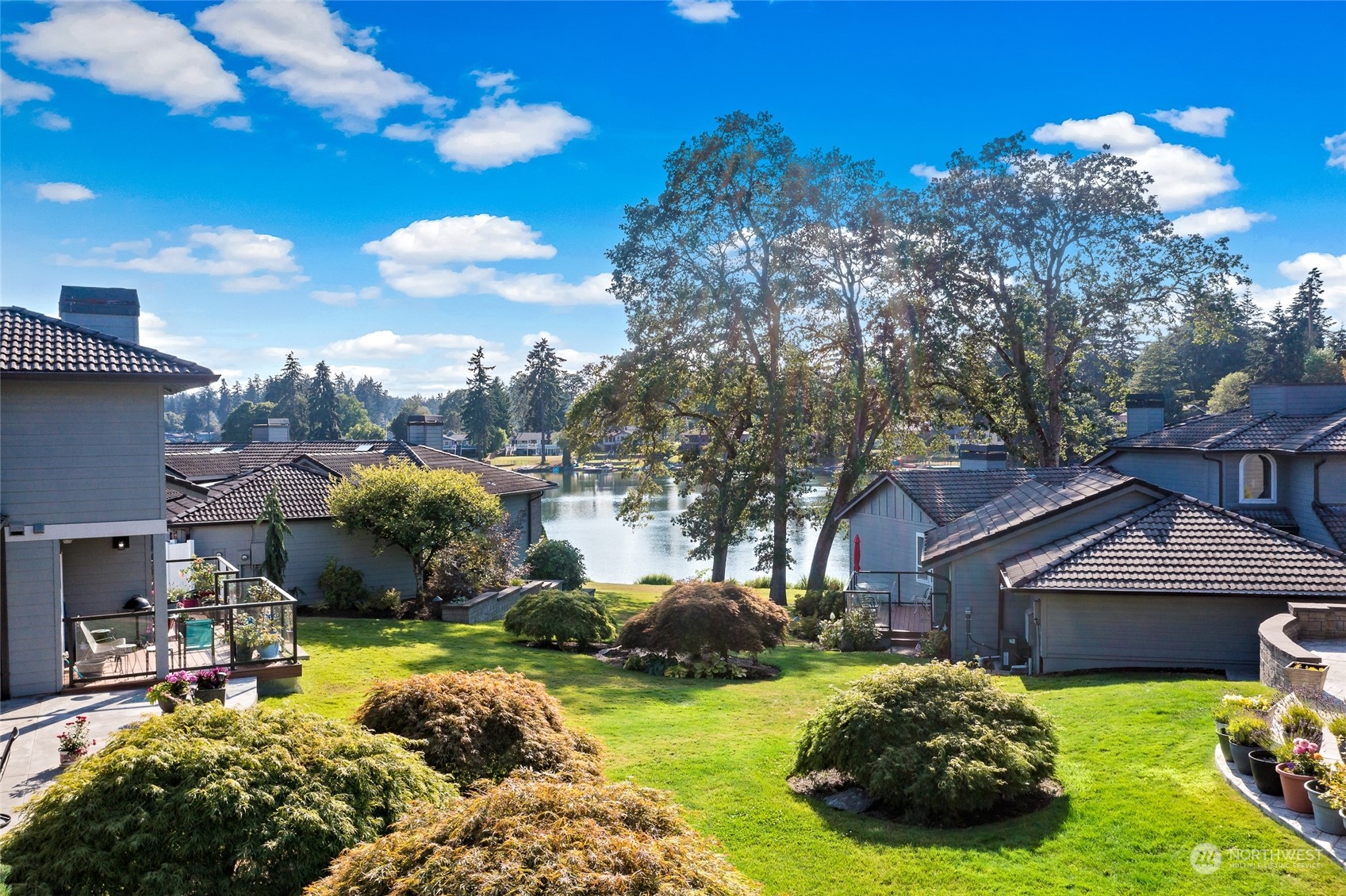 a view of a house with backyard and sitting area