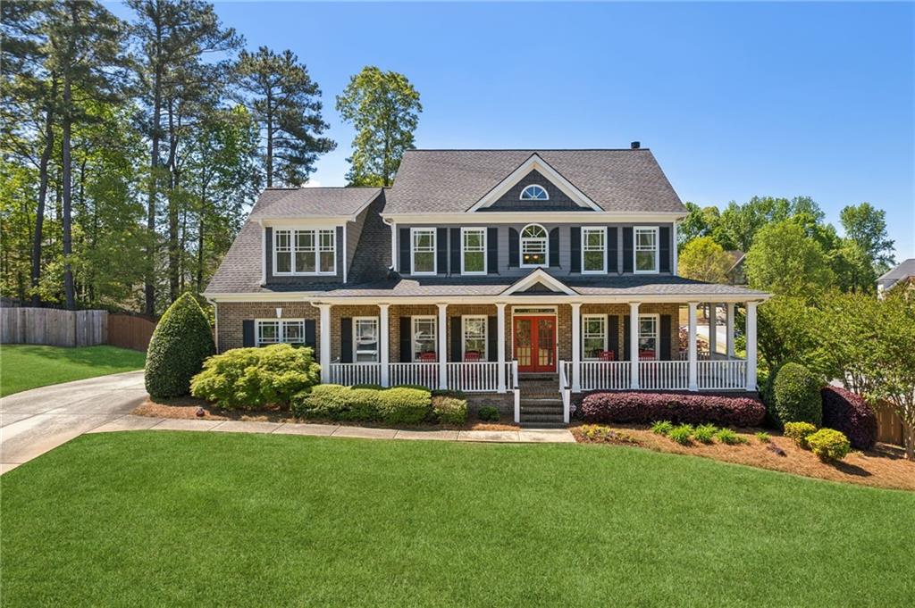 a front view of a house with a garden