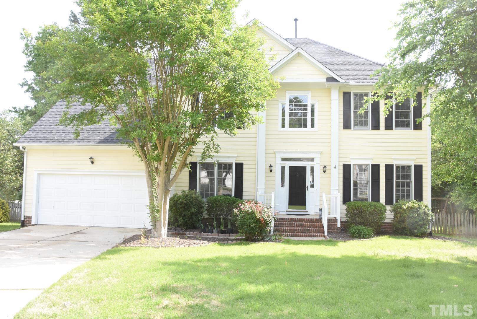 a view of a house with a yard and plants