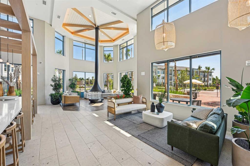 a living room with furniture fireplace and a large window