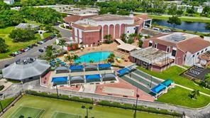 an aerial view of a house with swimming pool patio and lake view