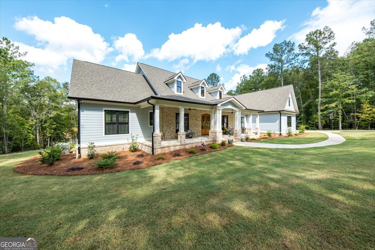 a front view of a house with a garden