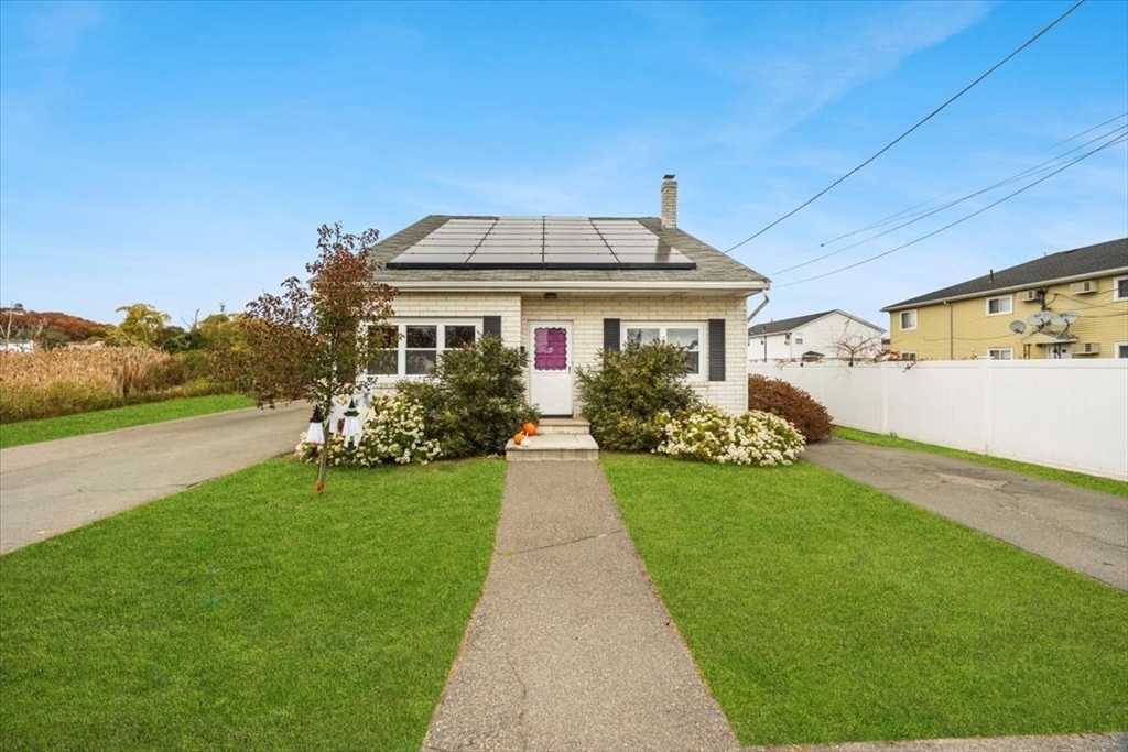 a front view of a house with a garden