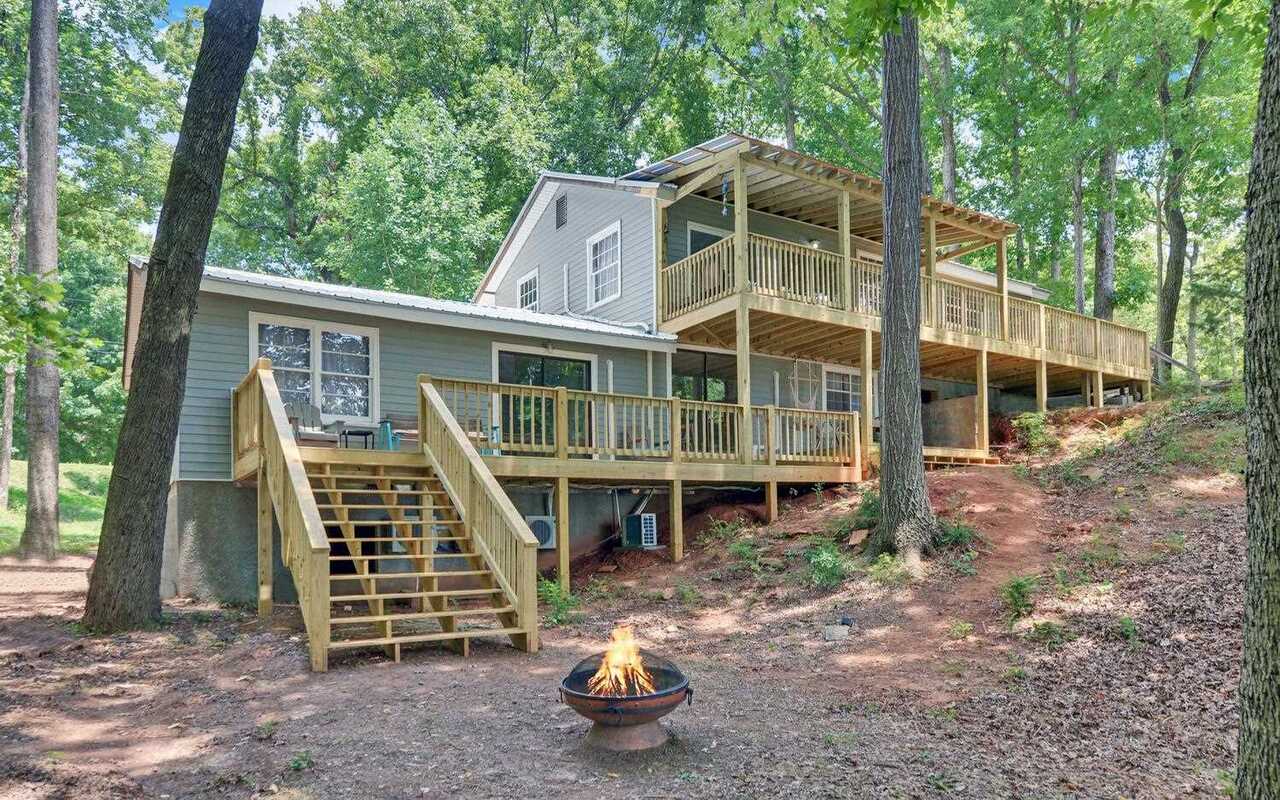 a view of a house with backyard and balcony