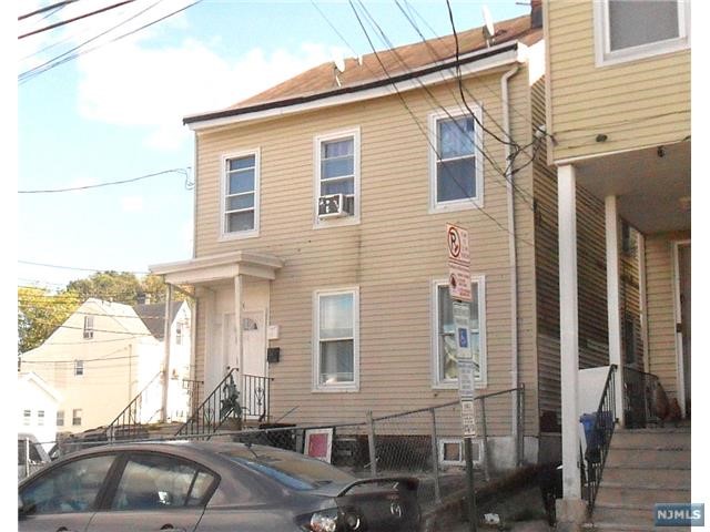 a front view of a house with parking