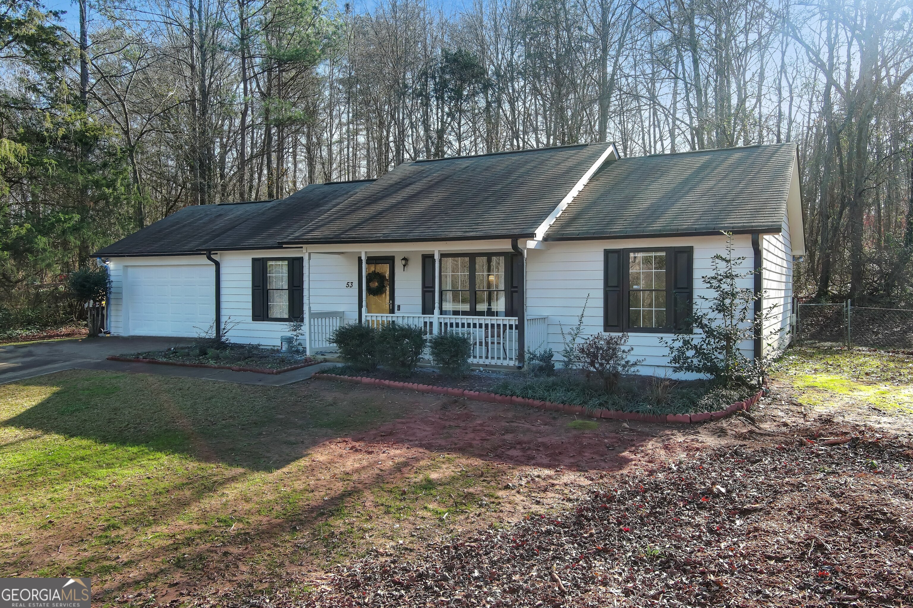 a front view of a house with a yard and pathway