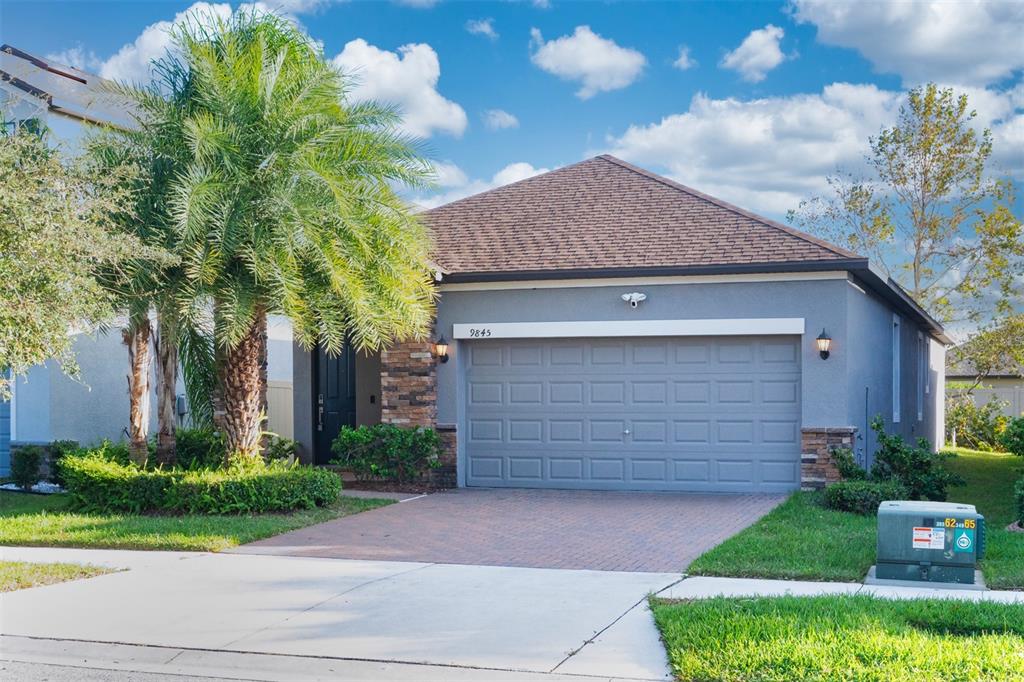 a front view of a house with a yard and garage