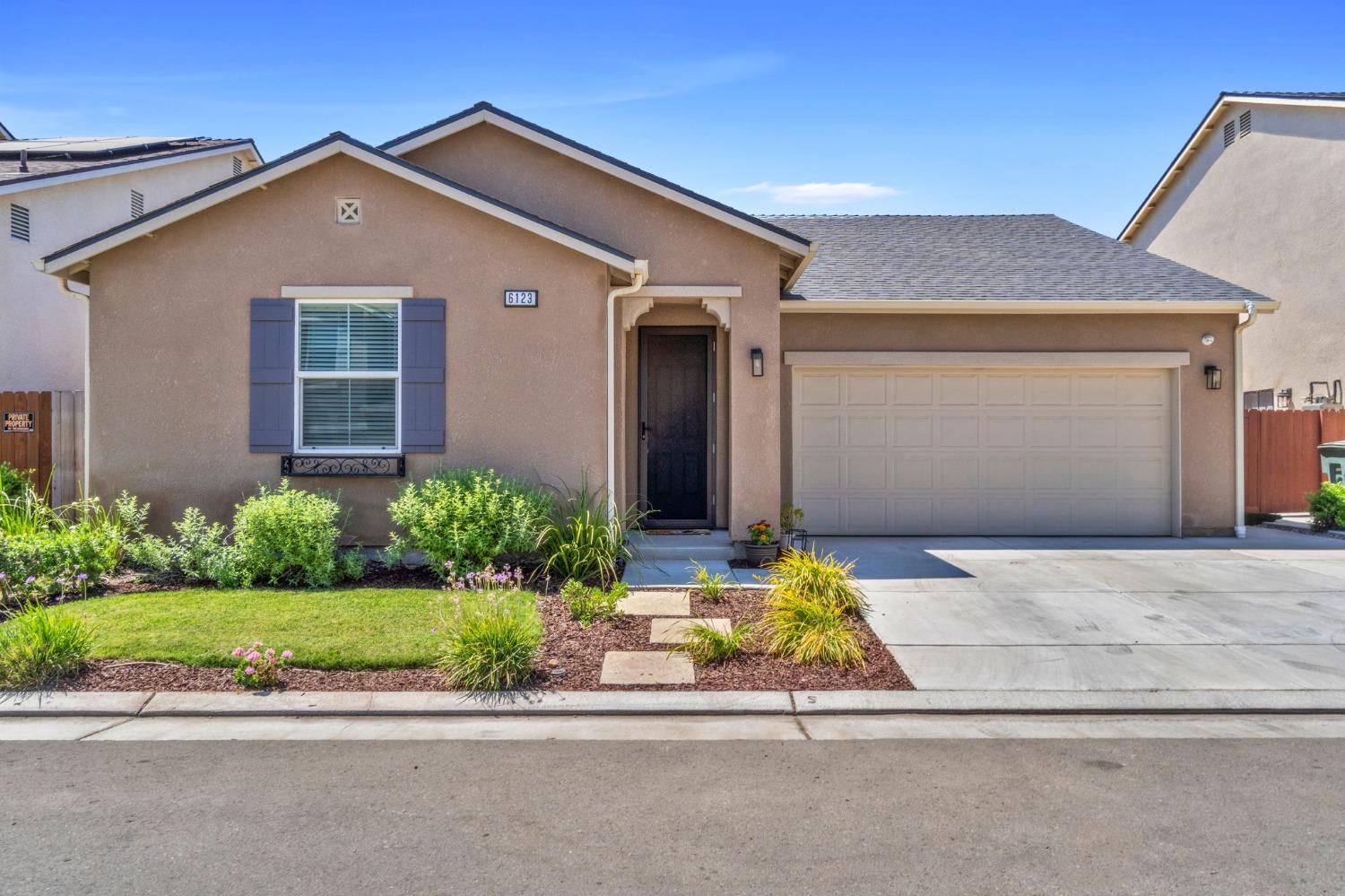 front view of a house and a small yard