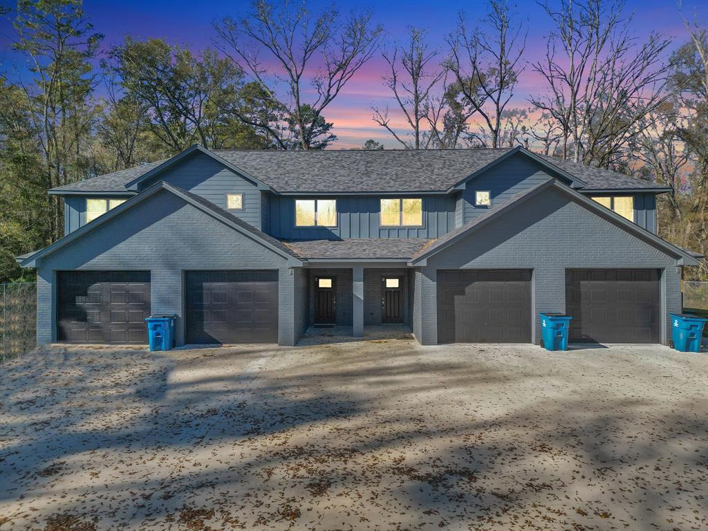 a view of a house with a yard and garage