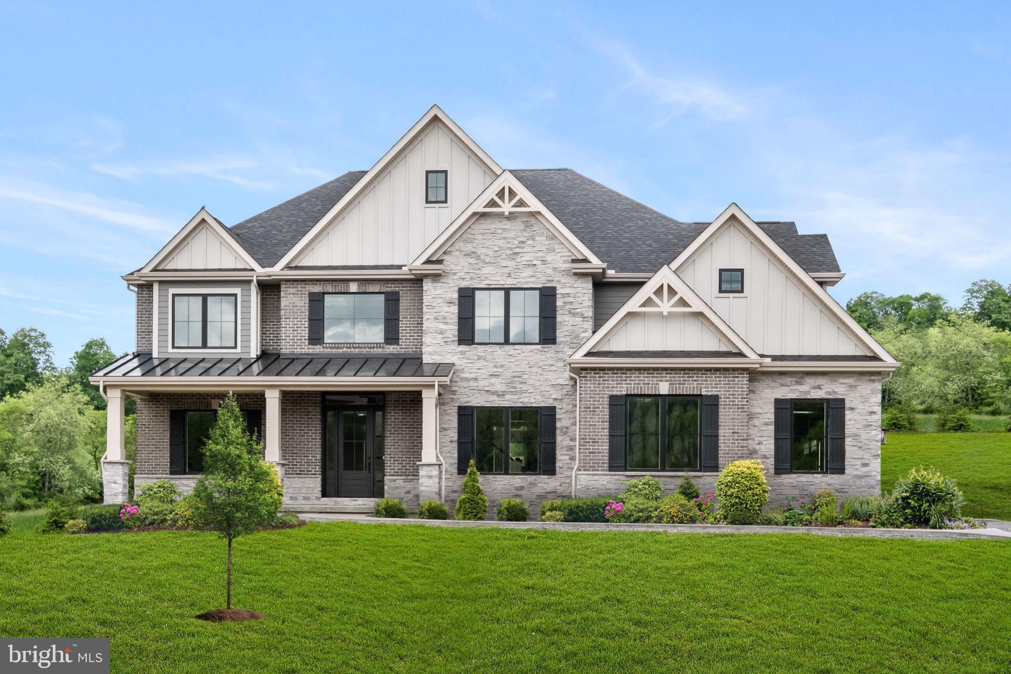 a front view of a house with a yard and trees