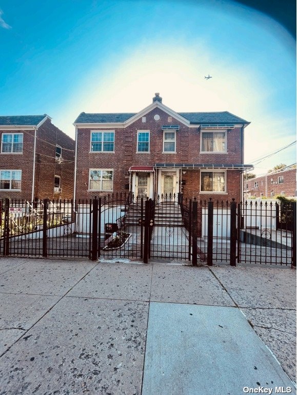 a view of a brick house with many windows