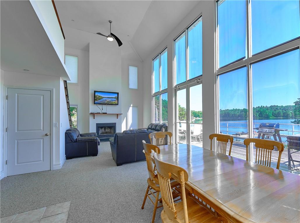 a living room with fireplace furniture and a large window