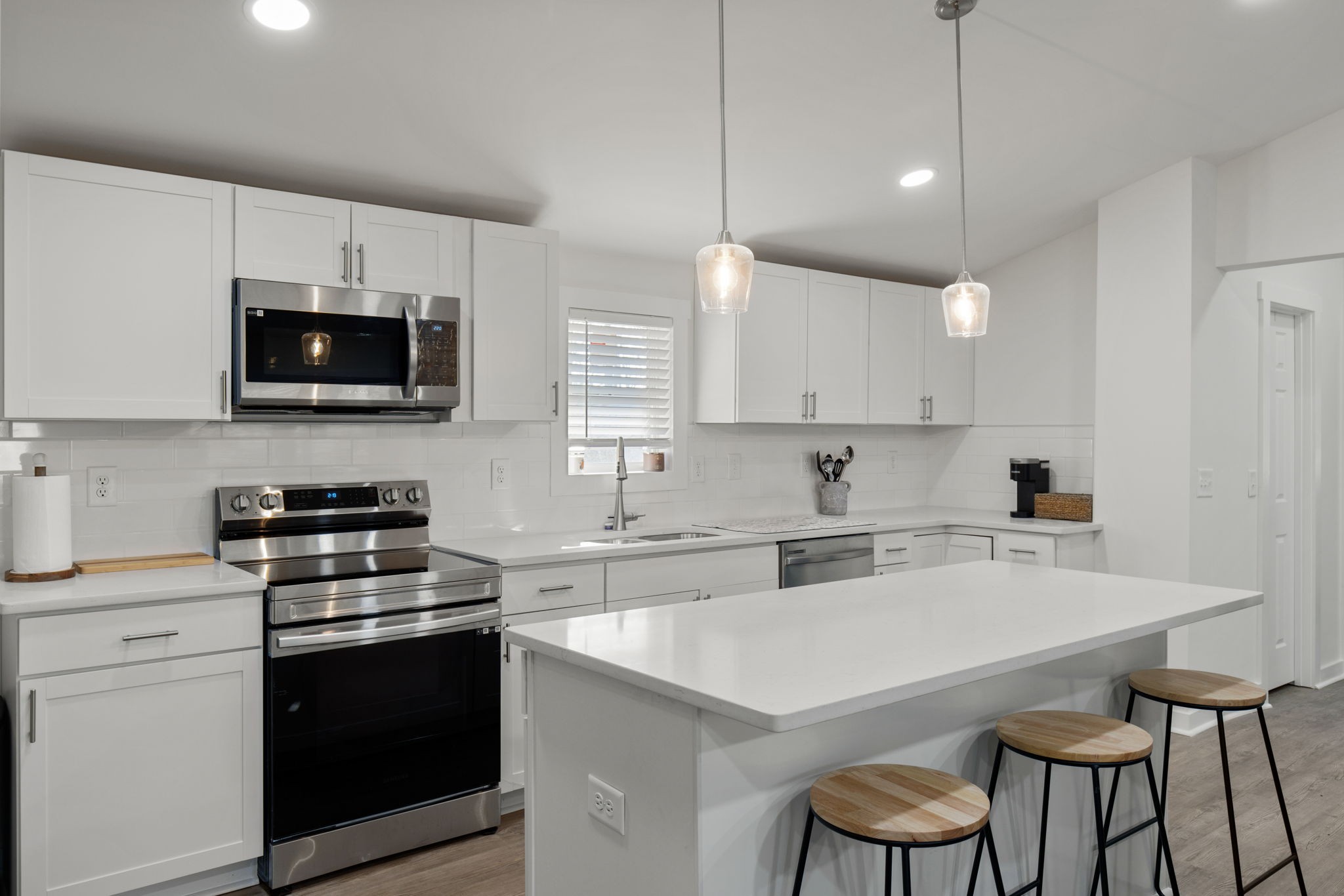 a kitchen with a stove a sink and a microwave