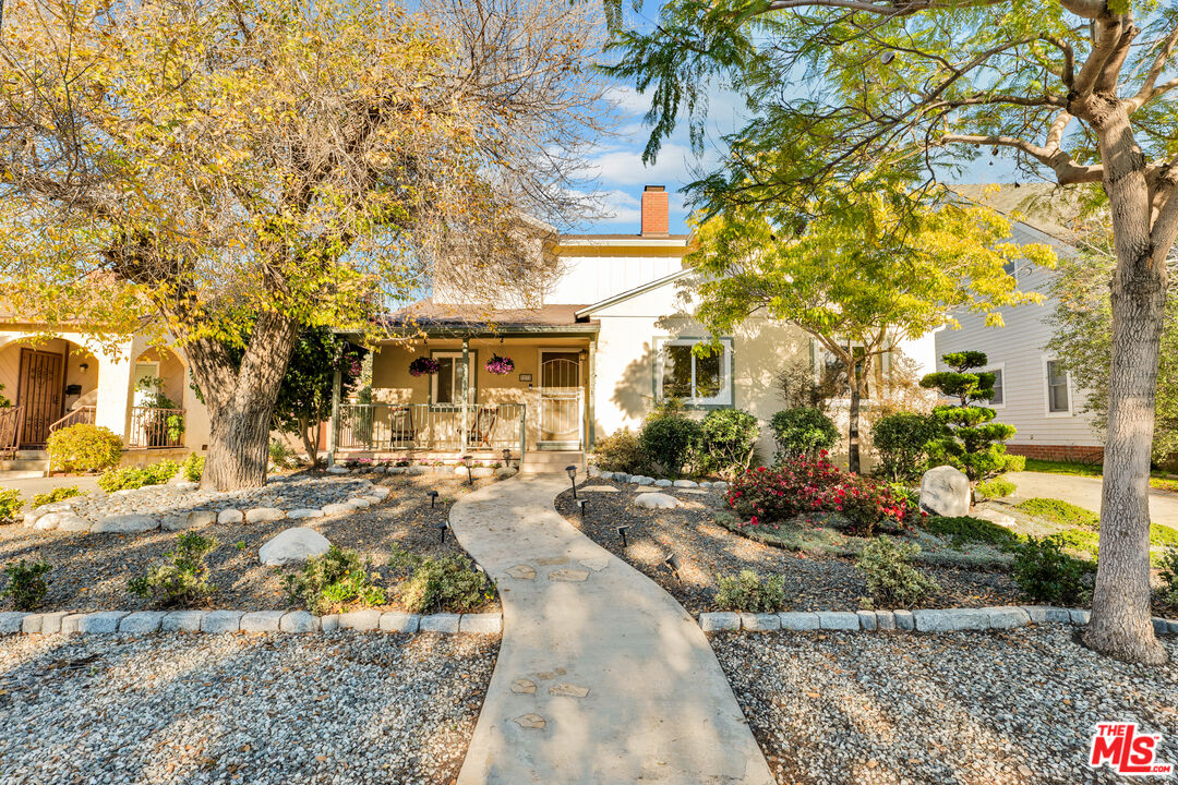 a view of a house with a tree in front