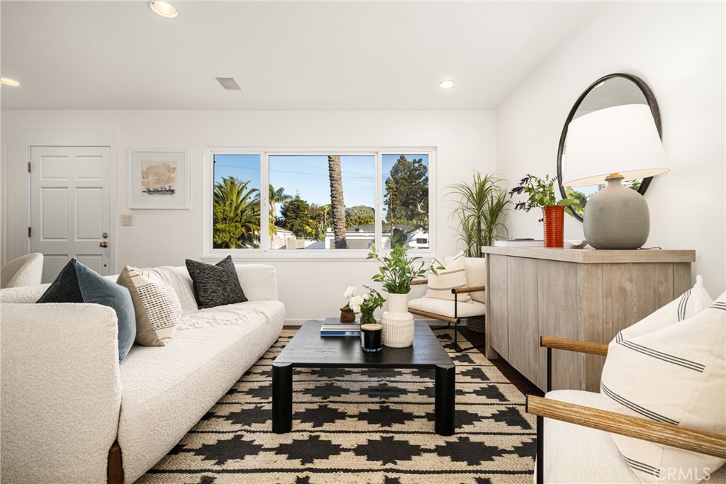 a living room with furniture and a potted plant