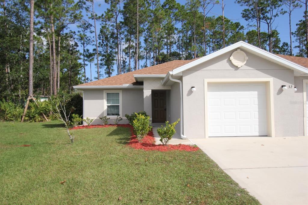 a front view of a house with a yard and porch