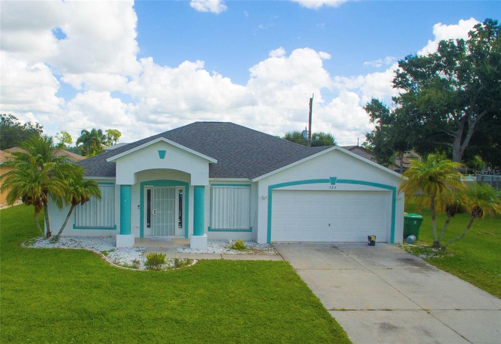 a front view of house with yard and green space