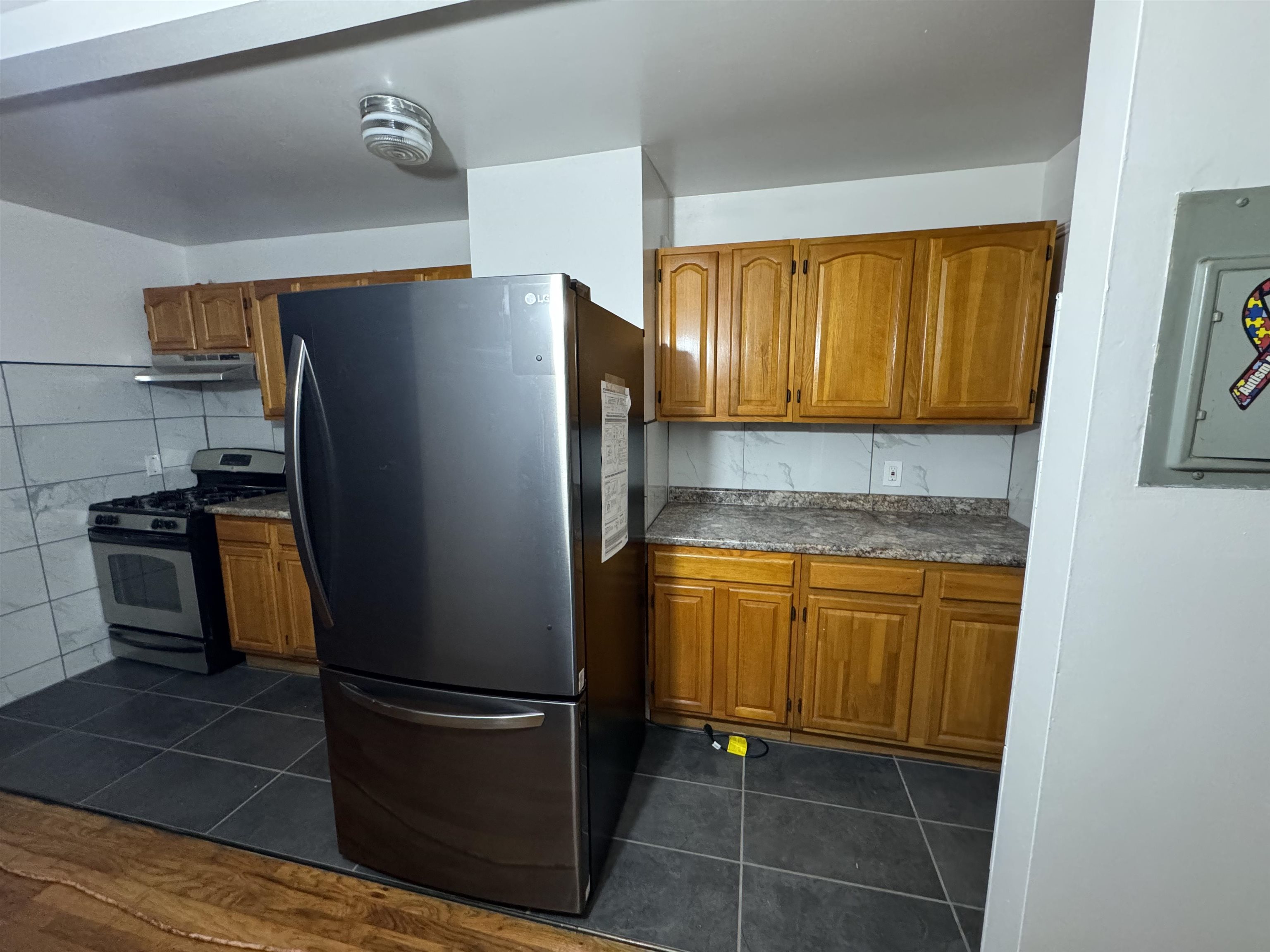 a kitchen with granite countertop stainless steel appliances and cabinets