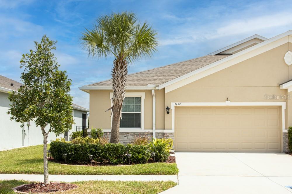 a front view of a house with garden