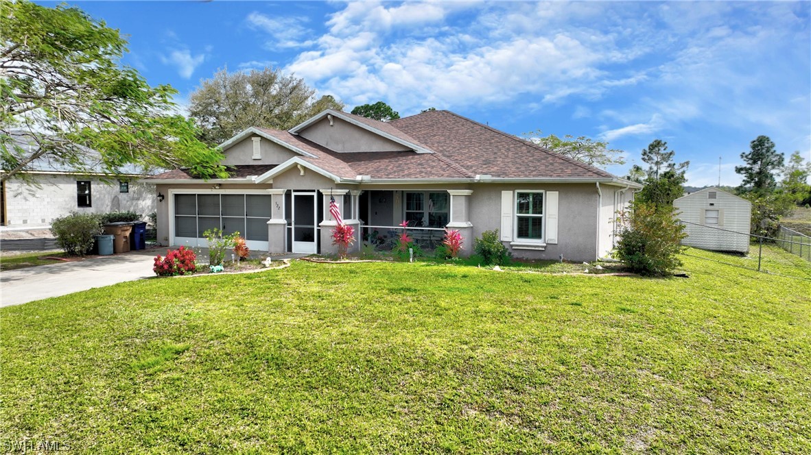 a view of a house with backyard and porch