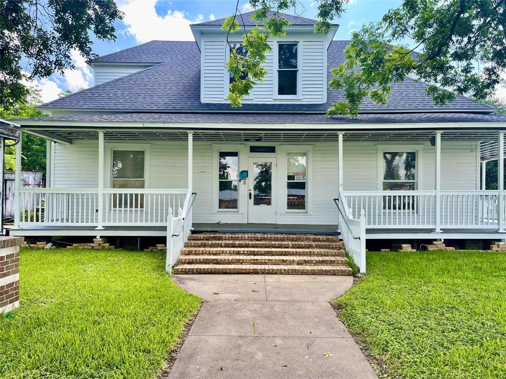 a front view of a house with a yard table and deck