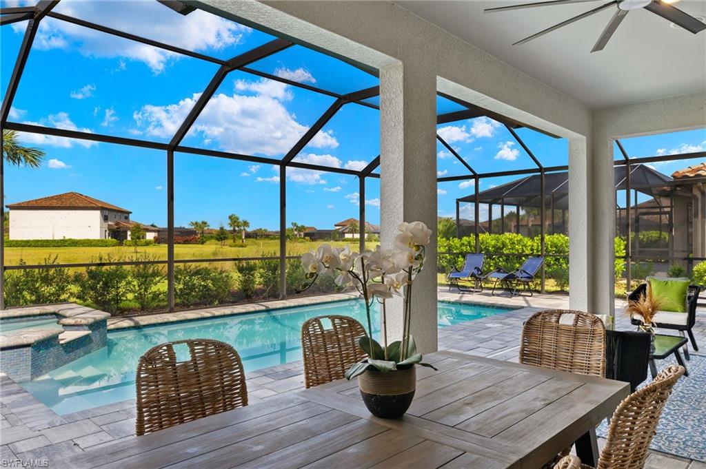 a dining room with furniture and a floor to ceiling window