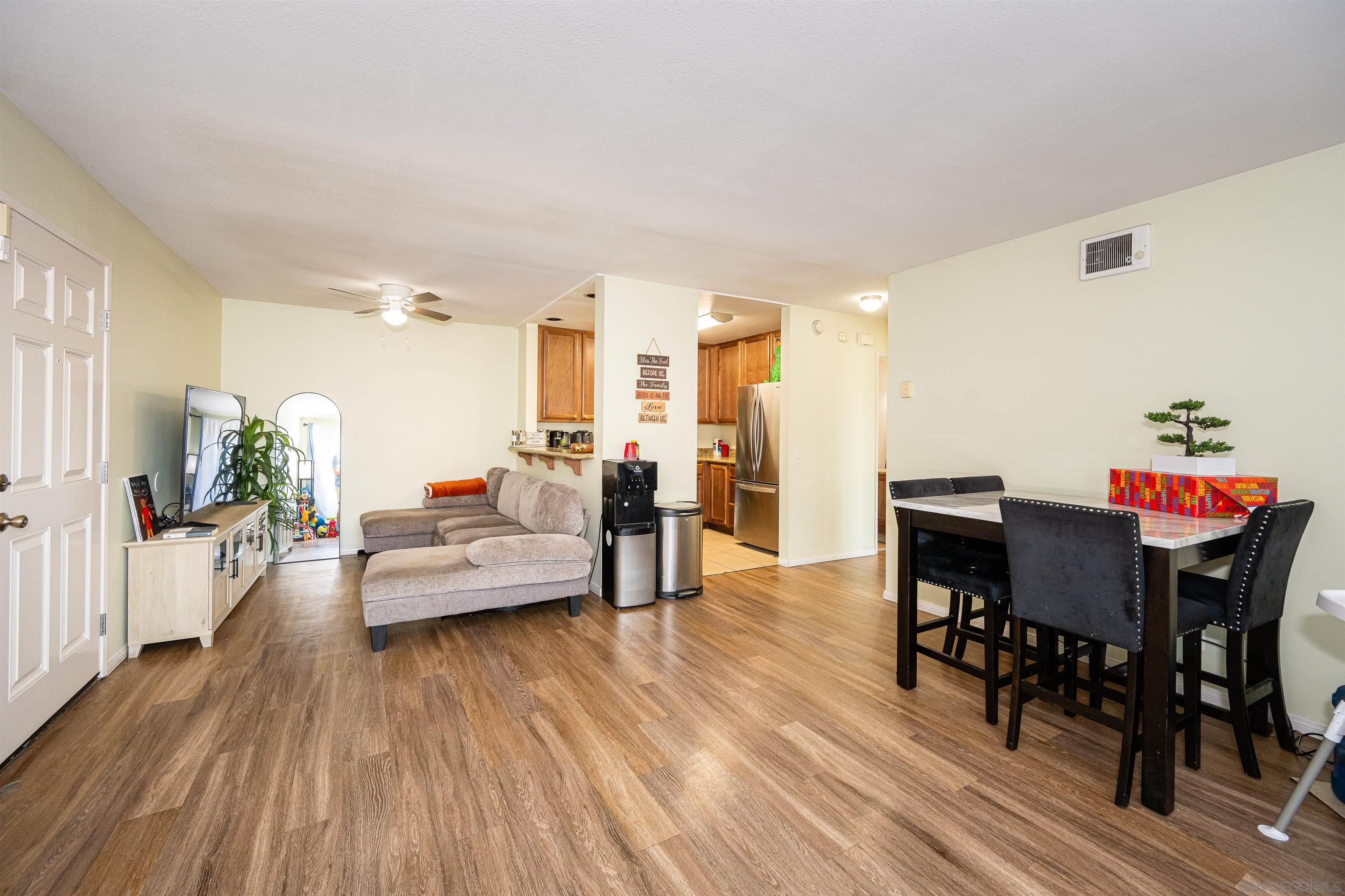 a living room with furniture and wooden floor