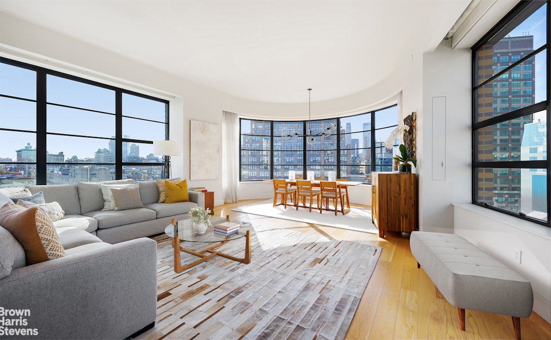 a living room with furniture and a floor to ceiling window