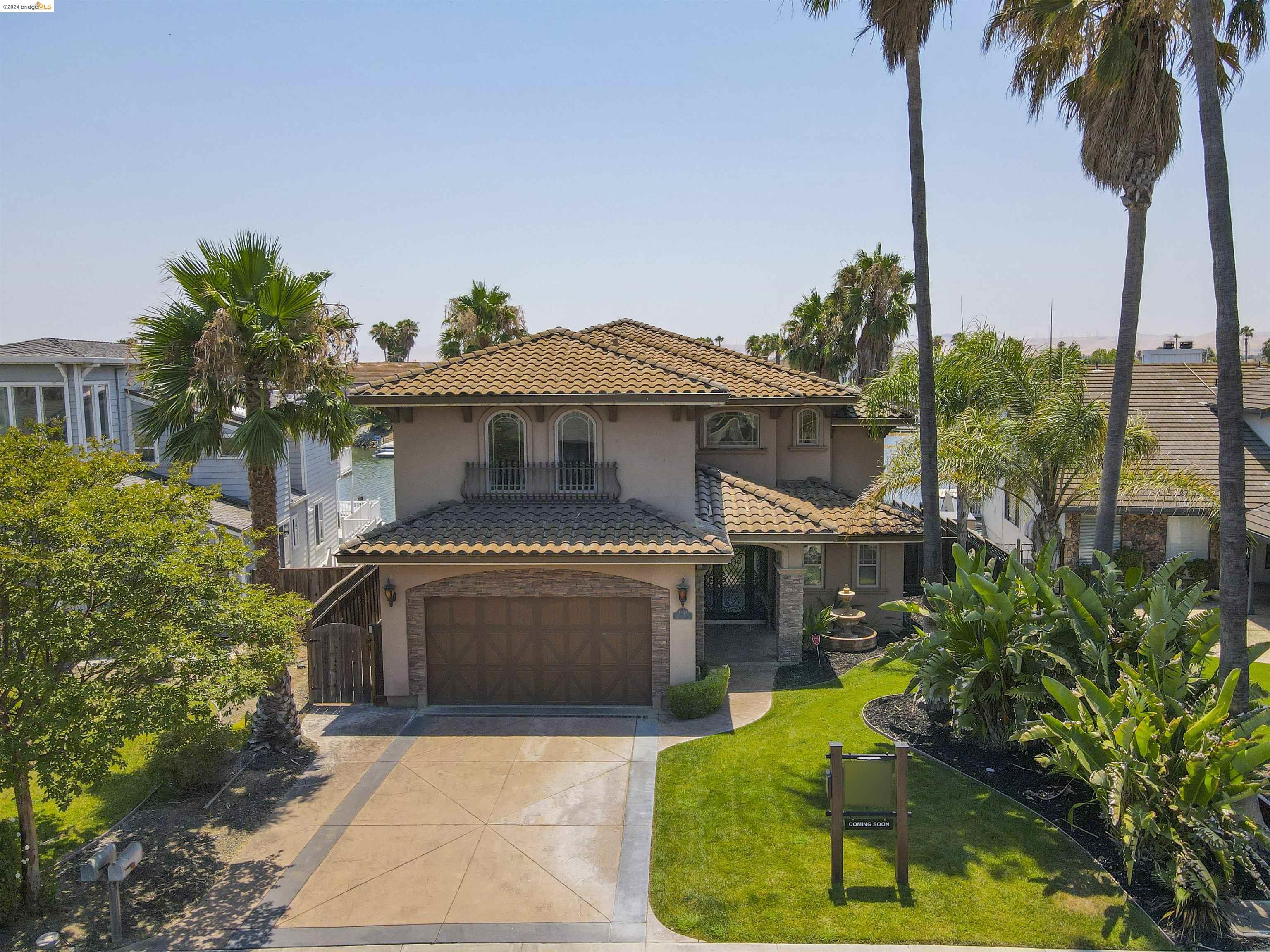 a front view of a house with a garden and yard