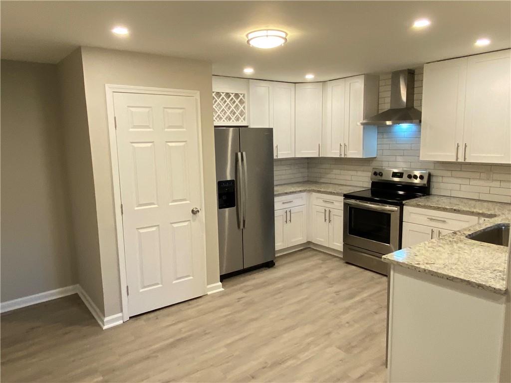 a kitchen with granite countertop a refrigerator and a sink