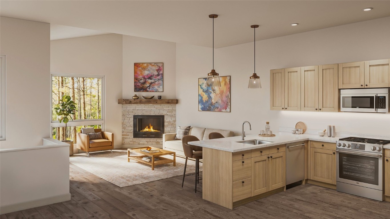 a kitchen with a sink stove and wooden floor