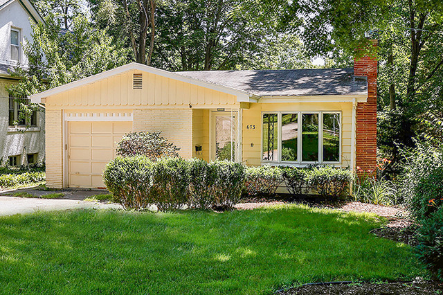 a front view of a house with a garden