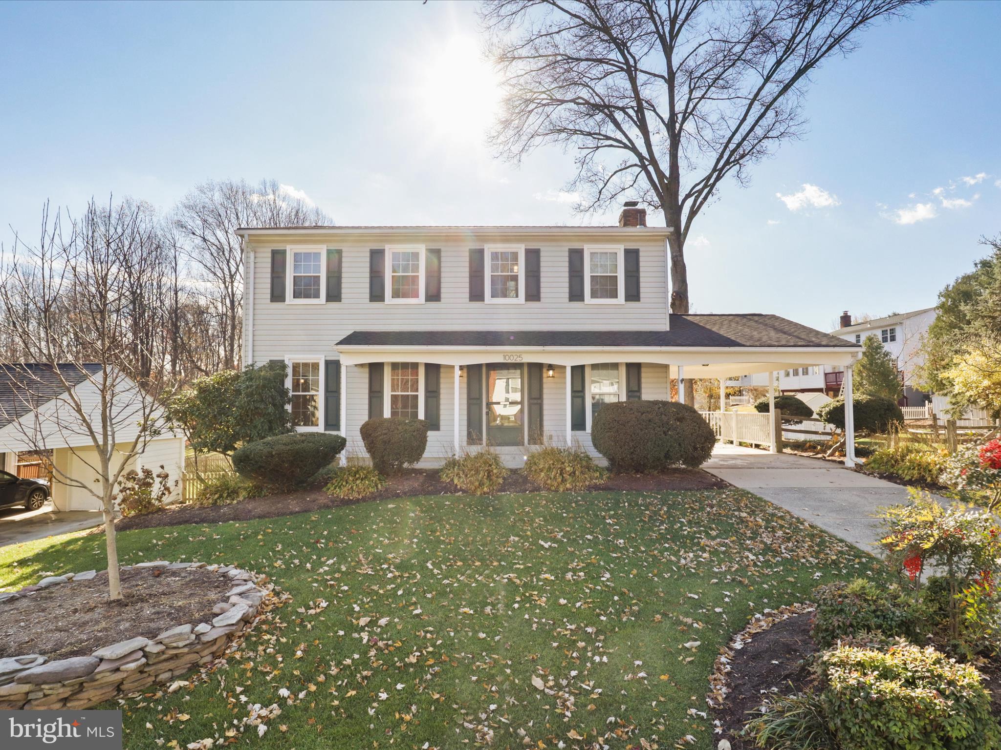 a front view of a house with yard and green space