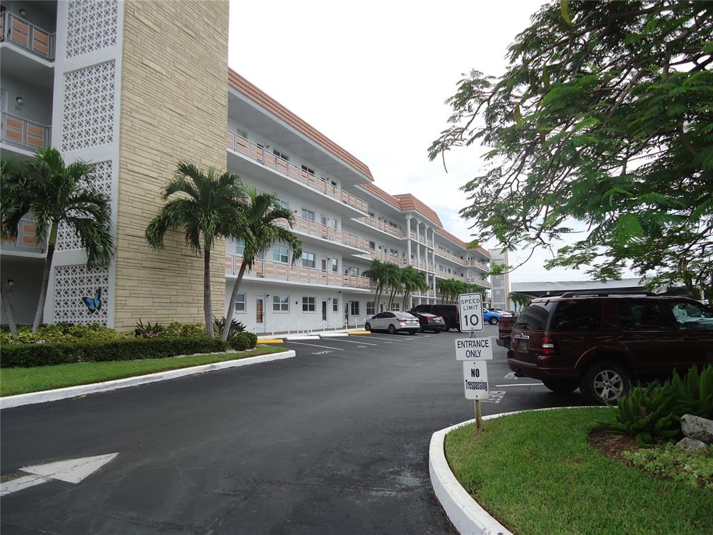 a view of a street with cars parked in front of it